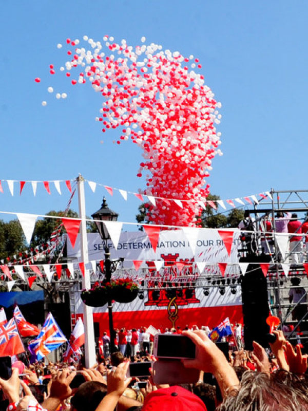 Gibraltar National Day celebration releasing red and white balloons image